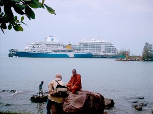 a photographer, a monk, and a cruise ship at the sihanoukville port.